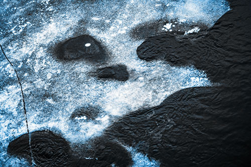 Disintegrating Ice Face Melting Among Flowing River Water (Blue Tone Photo)