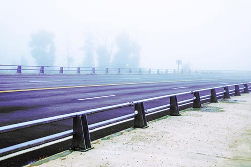 Fog Surrounds Deserted Sidewalk Roadway