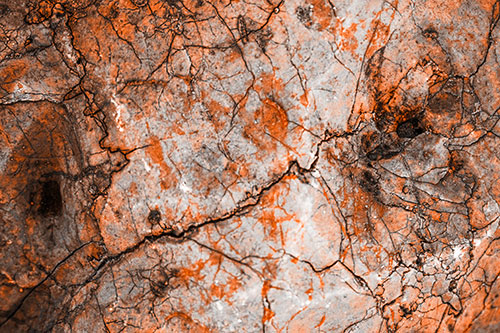 Smirking Chaos Cracked Rock Face (Orange Tone Photo)