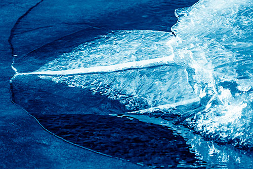Abstract Ice Sculpture Forms Atop Frozen River (Blue Shade Photo)