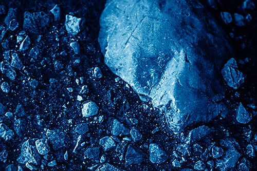 Alien Skull Rock Face Emerging Atop Dirt Surface (Blue Shade Photo)