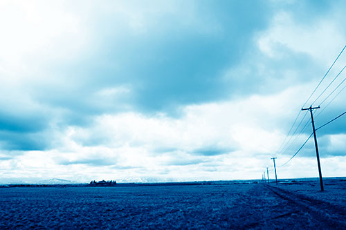 Bleak Clouded Sky Consumes Powerline Prairie (Blue Shade Photo)