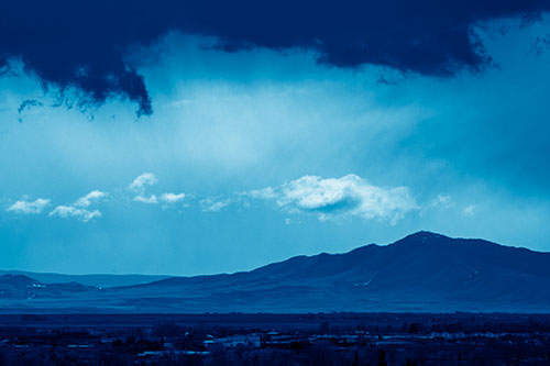 Dark Cloud Mass Above Mountain Range Horizon (Blue Shade Photo)