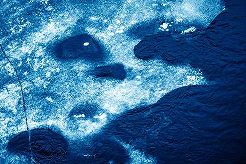 Disintegrating Ice Face Melting Among Flowing River Water (Blue Shade Photo)