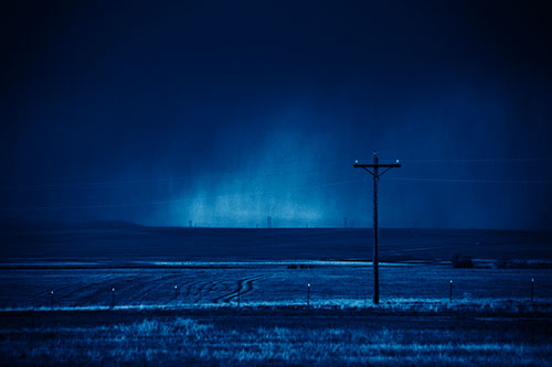 Distant Thunderstorm Rains Down Upon Powerlines (Blue Shade Photo)