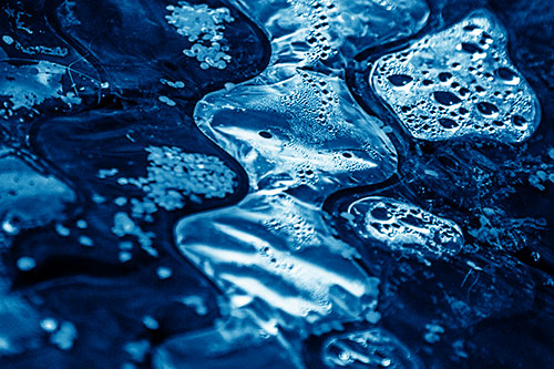 Distorted Plastic Bubble Face Floating Atop Water (Blue Shade)