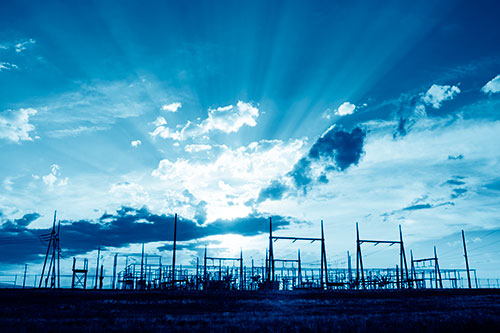 Electrical Substation Sunset Bursting Through Clouds (Blue Shade Photo)