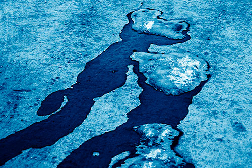 Melting Ice Puddles Forming Water Streams (Blue Shade Photo)