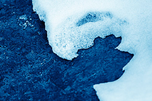 Screaming Snow Face Slowly Melting Atop Rock Surface (Blue Shade Photo)