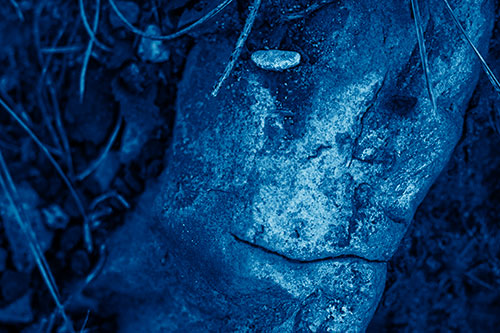 Smirking Battered Rock Face (Blue Shade Photo)