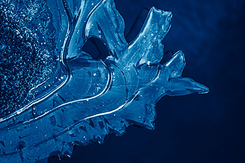 Smooth Ice Face Creature Hanging Above River Shoreline (Blue Shade)