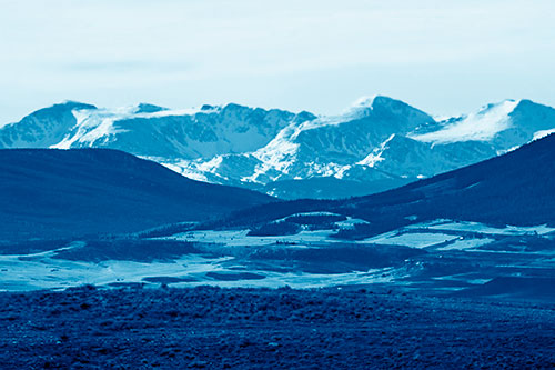 Snow Capped Mountains Behind Hills (Blue Shade Photo)