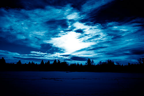 Sun Vortex Illuminates Clouds Above Dark Lit Lake (Blue Shade Photo)