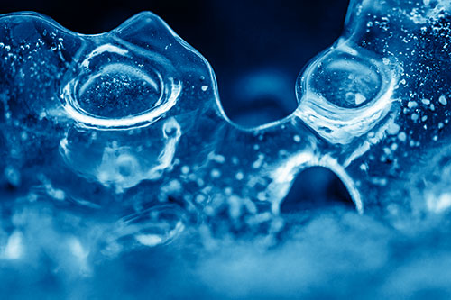Vertical Bubble Eyed Screaming Ice Face Along Frozen River (Blue Shade Photo)