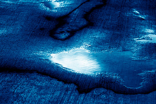 Water Puddles Dissipating After Rainstorm (Blue Shade Photo)