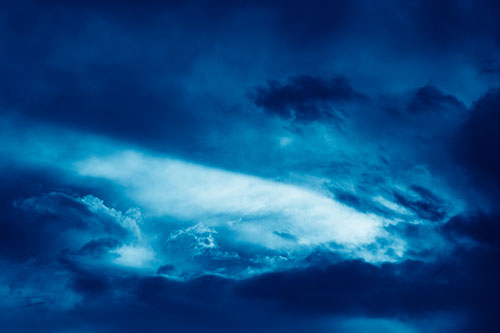 White Light Tearing Through Clouds (Blue Shade Photo)