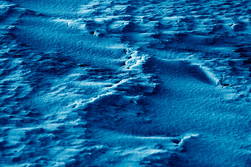 Wind Blowing Across Jagged Frozen Snow Drift (Blue Shade Photo)