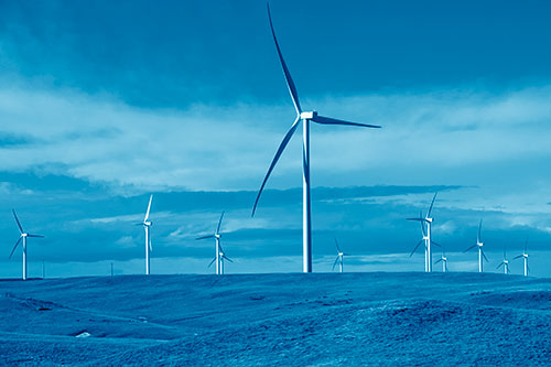Wind Turbine Cluster Scattered Across Land (Blue Shade Photo)