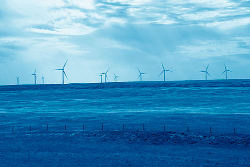 Wind Turbines Scattered Along The Prairie Horizon (Blue Shade Photo)