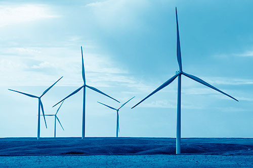 Wind Turbines Standing Tall On Green Pasture (Blue Shade Photo)
