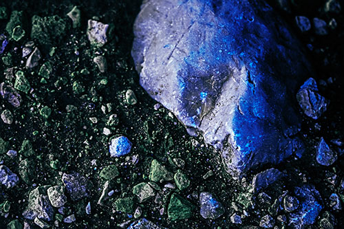 Alien Skull Rock Face Emerging Atop Dirt Surface (Blue Tint Photo)