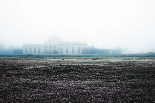 Dense Fog Consumes Distant Historic State Penitentiary (Blue Tint Photo)