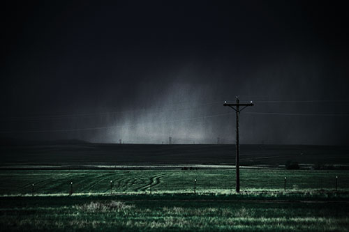 Distant Thunderstorm Rains Down Upon Powerlines (Blue Tint Photo)