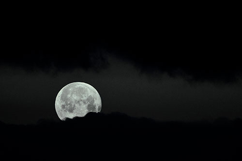 Easter Morning Moon Peeking Through Clouds (Blue Tint Photo)