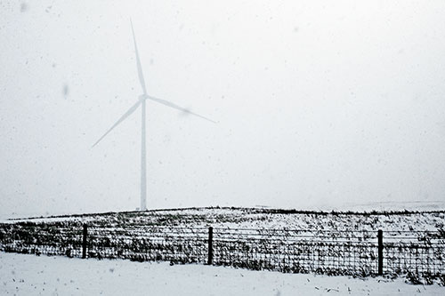 Fenced Wind Turbine Among Blowing Snow (Blue Tint Photo)