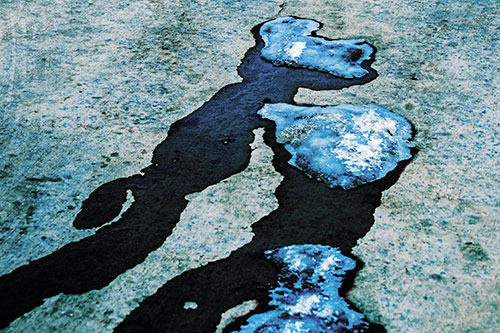 Melting Ice Puddles Forming Water Streams (Blue Tint Photo)
