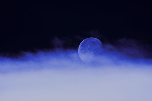 Moon Rolling Along Clouds (Blue Tint Photo)