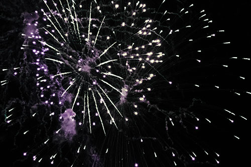 Multiple Firework Explosions Send Light Orbs Flying (Blue Tint Photo)