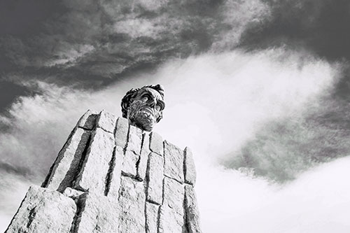 Presidents Statue Standing Tall Among Clouds (Blue Tint Photo)