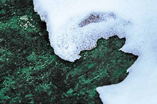 Screaming Snow Face Slowly Melting Atop Rock Surface (Blue Tint Photo)