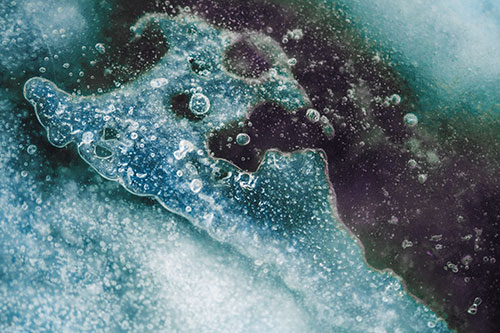 Screaming Submerged Bubble Face Creature Among Icy River (Blue Tint Photo)