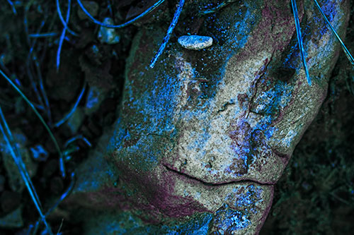 Smirking Battered Rock Face (Blue Tint Photo)