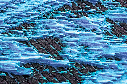 Snow Drifts Atop Rigid Pavement (Blue Tint Photo)