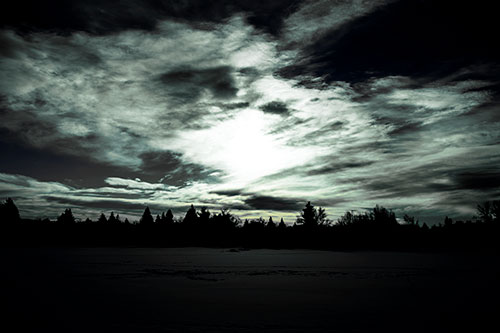 Sun Vortex Illuminates Clouds Above Dark Lit Lake (Blue Tint Photo)