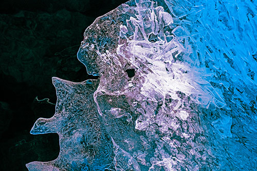 Two Faced Optical Illusion Ice Face Hanging Above River (Blue Tint Photo)