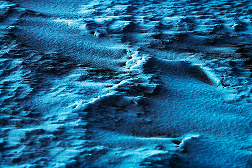 Wind Blowing Across Jagged Frozen Snow Drift (Blue Tint Photo)