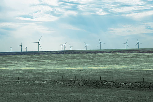 Wind Turbines Scattered Along The Prairie Horizon (Blue Tint Photo)