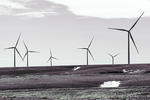Wind Turbines Scattered Around Melting Snow Patches (Blue Tint Photo)
