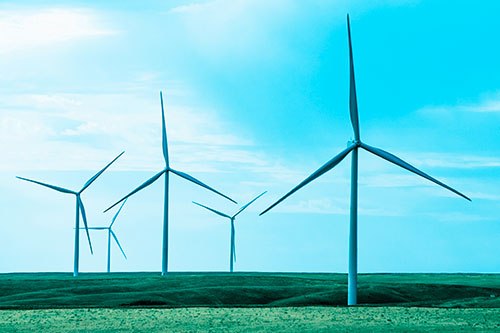 Wind Turbines Standing Tall On Green Pasture (Blue Tint Photo)