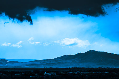 Dark Cloud Mass Above Mountain Range Horizon (Blue Tone Photo)