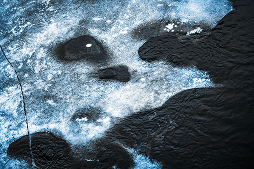 Disintegrating Ice Face Melting Among Flowing River Water (Blue Tone)