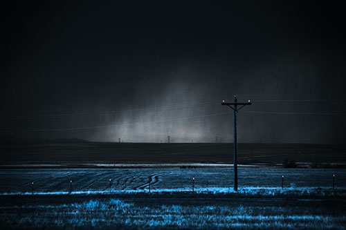 Distant Thunderstorm Rains Down Upon Powerlines (Blue Tone Photo)