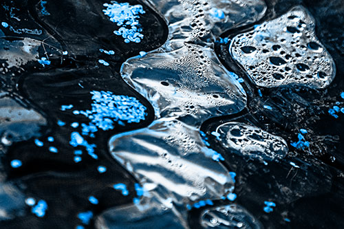Distorted Plastic Bubble Face Floating Atop Water (Blue Tone)