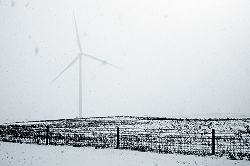 Fenced Wind Turbine Among Blowing Snow (Blue Tone Photo)