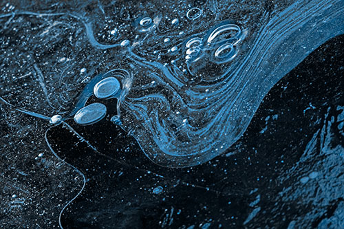 Frozen Bubble Clusters Among Twirling River Ice (Blue Tone Photo)