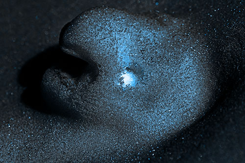 Glowing Eyed Snow Face Emerges Above Soil (Blue Tone)